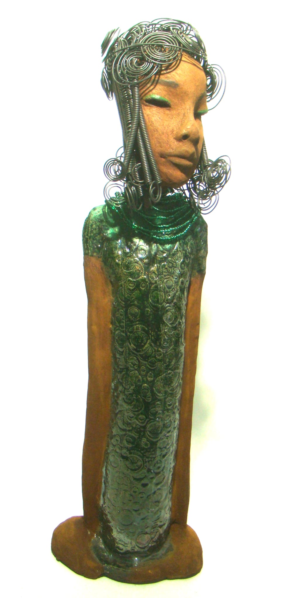 Felicia stands 25" x 8" x 6". and weighs 8.14 Lbs. She has a honey brown complexion with with over 40 feet of fancy wire hair. Felicia dress is textured alligator green. She wears emerald green bead. She really does have a sweet face.