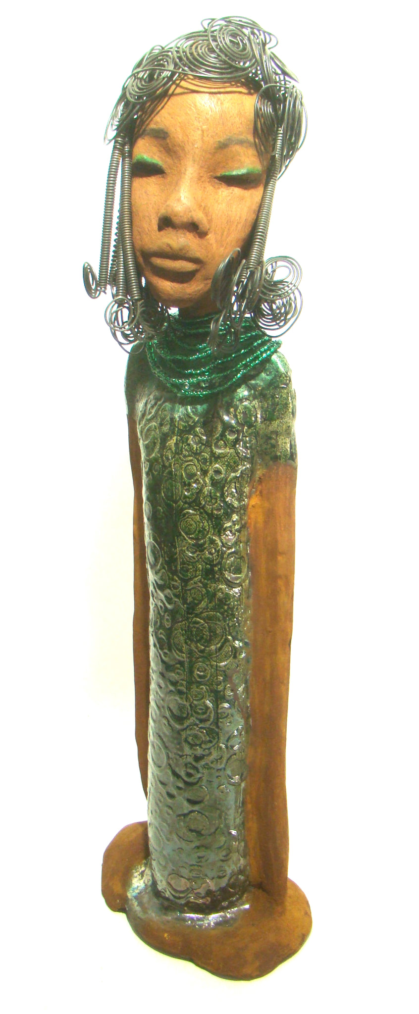 Felicia stands 25" x 8" x 6". and weighs 8.14 Lbs. She has a honey brown complexion with with over 40 feet of fancy wire hair. Felicia dress is textured alligator green. She wears emerald green bead. She really does have a sweet face.