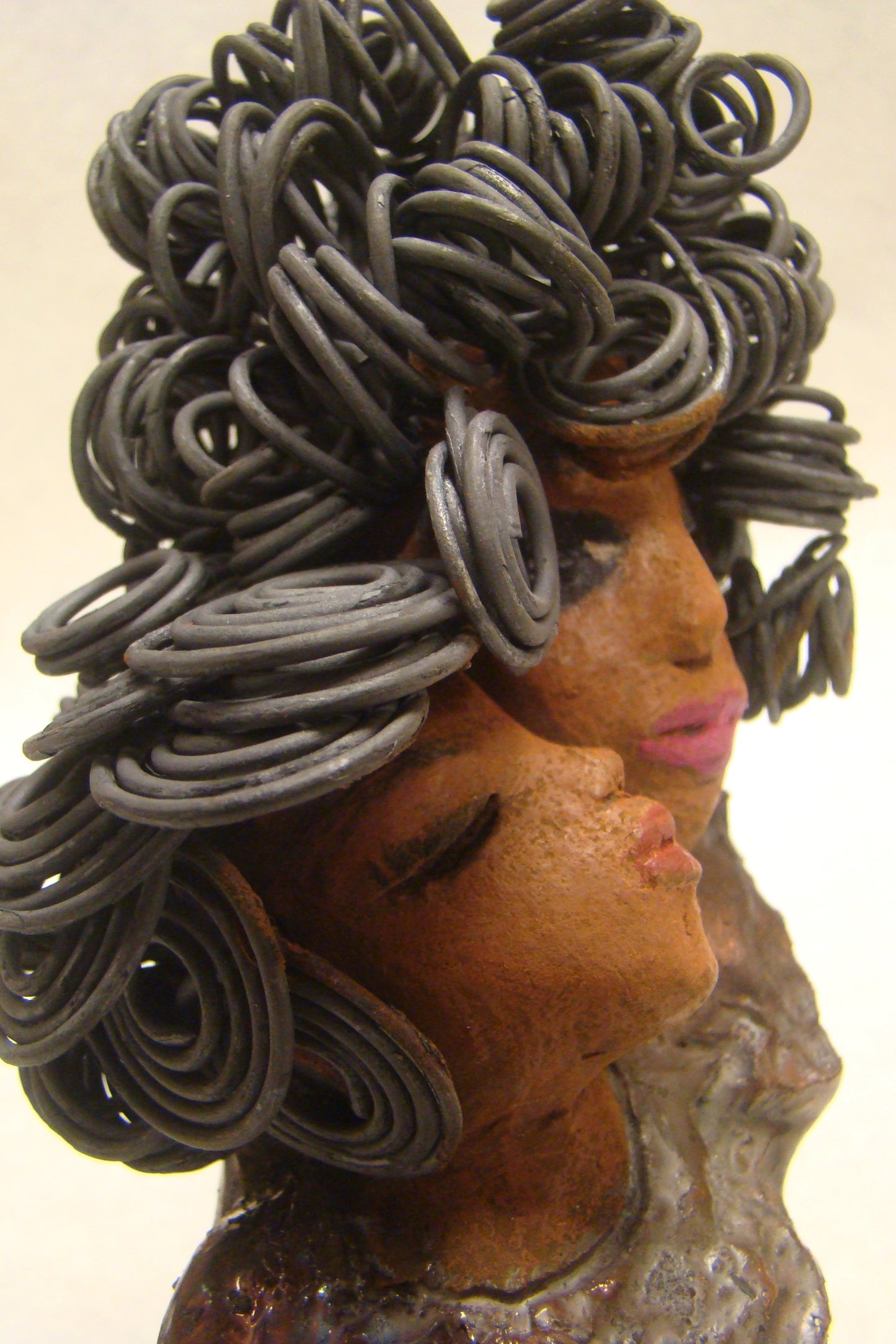 I Love You More stands 8.5 " x 4.5" x 4".5" and weighs 2.10 lbs. They have lovely honey brown complexions. Combined, I Love You More has over 25 feet of curly wire hair. They have glossy metallic copper dresses. They have long loving arms. One  is embracing the other. I Love You More! will  help illustrate the love that is in your home! Free Shipping!
