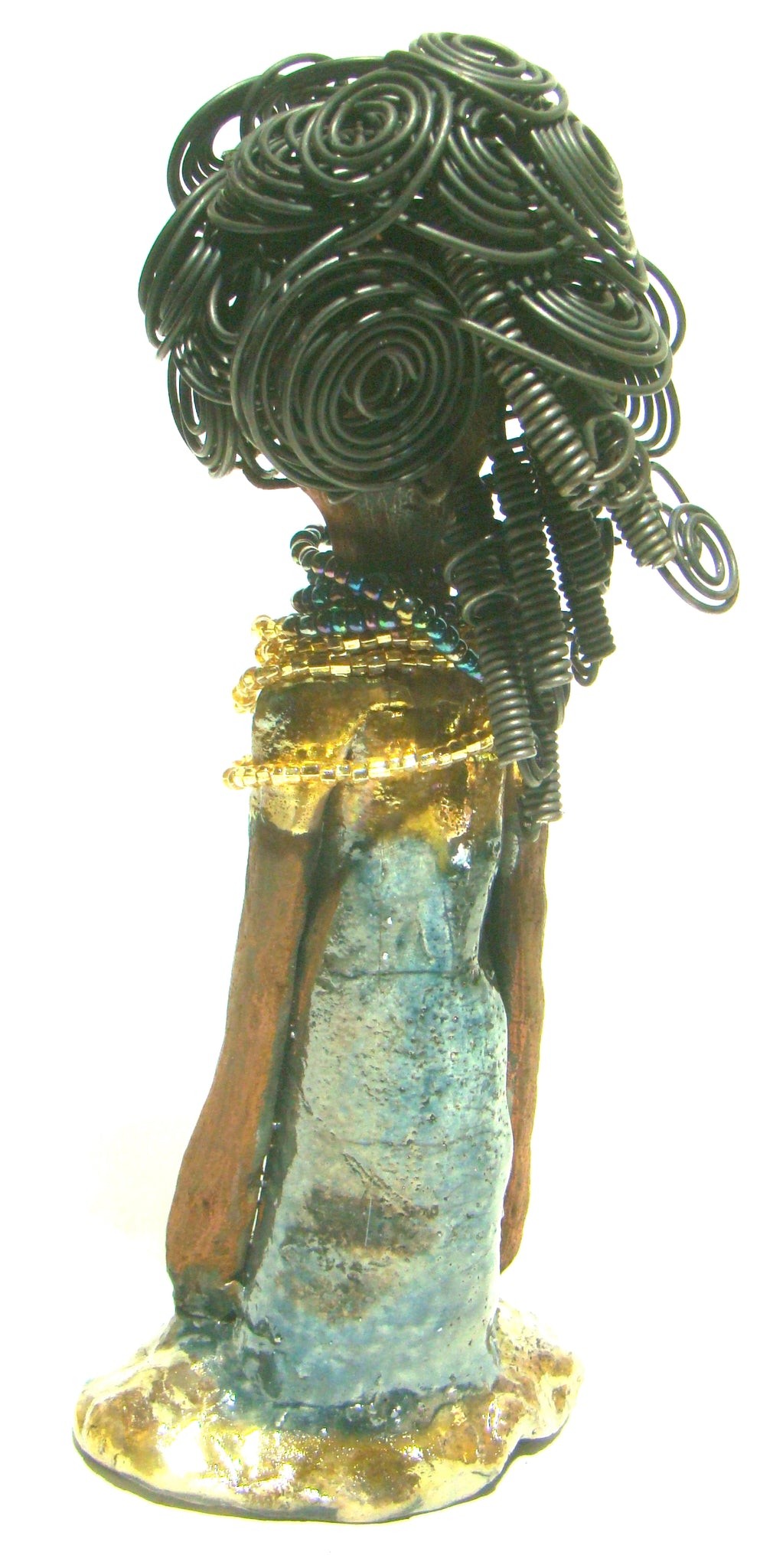 Sophia stands 10.5" x 4" x 3" and weighs 1.10 lbs. She has a  honey brown complexion with curls, coils and twisted, wire hair. Sophia wears a light blue crackle dress with a dazzling gold and multicolored beaded necklace.