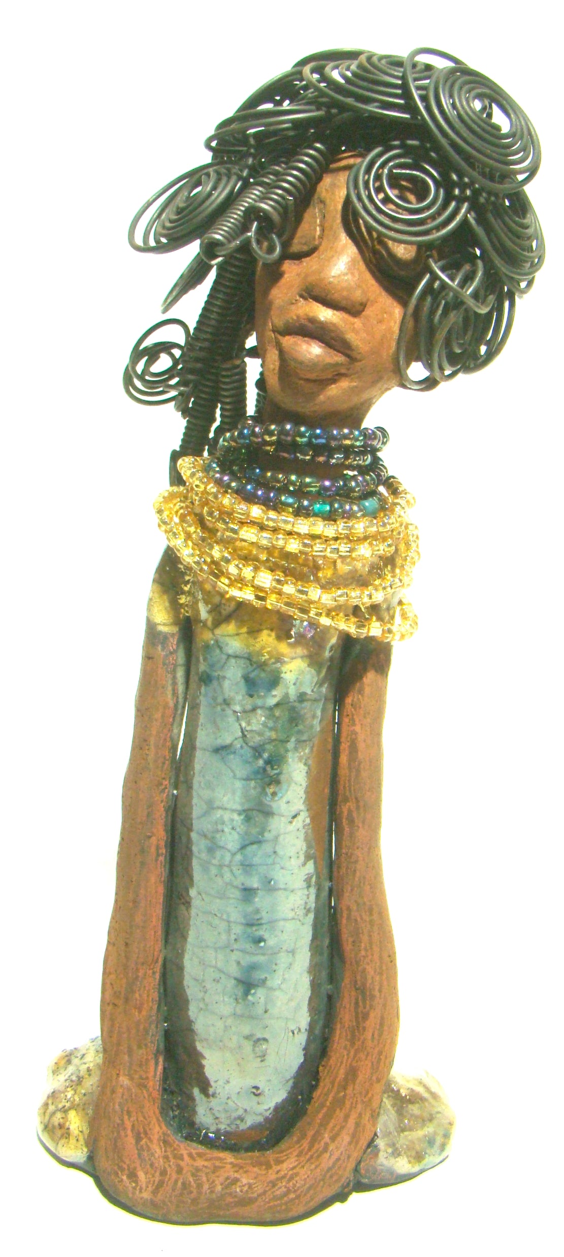Sophia stands 10.5" x 4" x 3" and weighs 1.10 lbs. She has a  honey brown complexion with curls, coils and twisted, wire hair. Sophia wears a light blue crackle dress with a dazzling gold and multicolored beaded necklace.