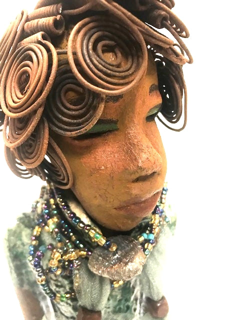 Meet Dorothy!      Dorothy states 15" x 5" x 3 and weighs 2.7 lbs     She has a lovely honey brown complexion.     Dorothy wears a green metallic dress with a beaded tulle around her neck.     It took over 3 hours to complete Dorothy's Herdew.     The hair is made of 16 gauge wire.     Dorothy long loving arms are at her sides.  Give Dorothy as a special gift or a special place in your home.   