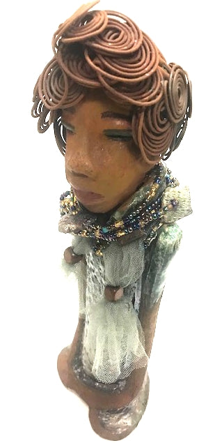 Meet Dorothy!      Dorothy states 15" x 5" x 3 and weighs 2.7 lbs     She has a lovely honey brown complexion.     Dorothy wears a green metallic dress with a beaded tulle around her neck.     It took over 3 hours to complete Dorothy's Herdew.     The hair is made of 16 gauge wire.     Dorothy long loving arms are at her sides.  Give Dorothy as a special gift or a special place in your home.   