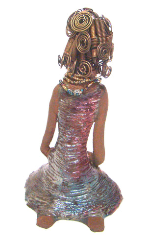 Gloria  is a raku fired and stands 12" x 7" x 5" and weighs 2.1lbs. She has a lovely brown complexion. Gloria's hair is gold and black. It took over 3 hours and 40 feet of coils and spiral 16 guage wire to complete.