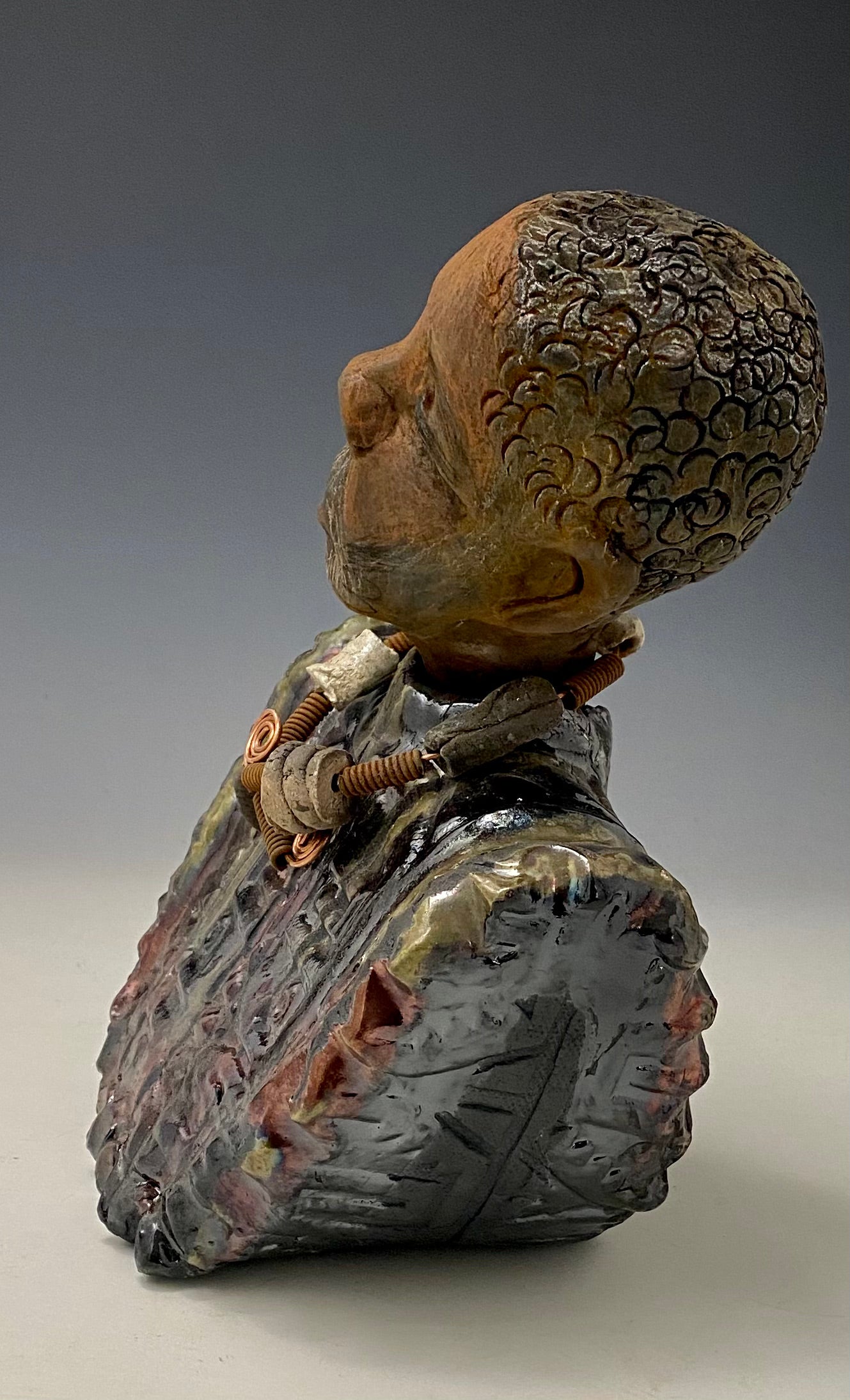 Meet James! James stands 10" x 7" x 5.5" and weighs 3.5lbs. James wears a colorful metallic gold, blue and copper dashiki. He is bald and bearded and partially grey. Yes ,,,,,,He is one of few Men found in the Herdew collection!