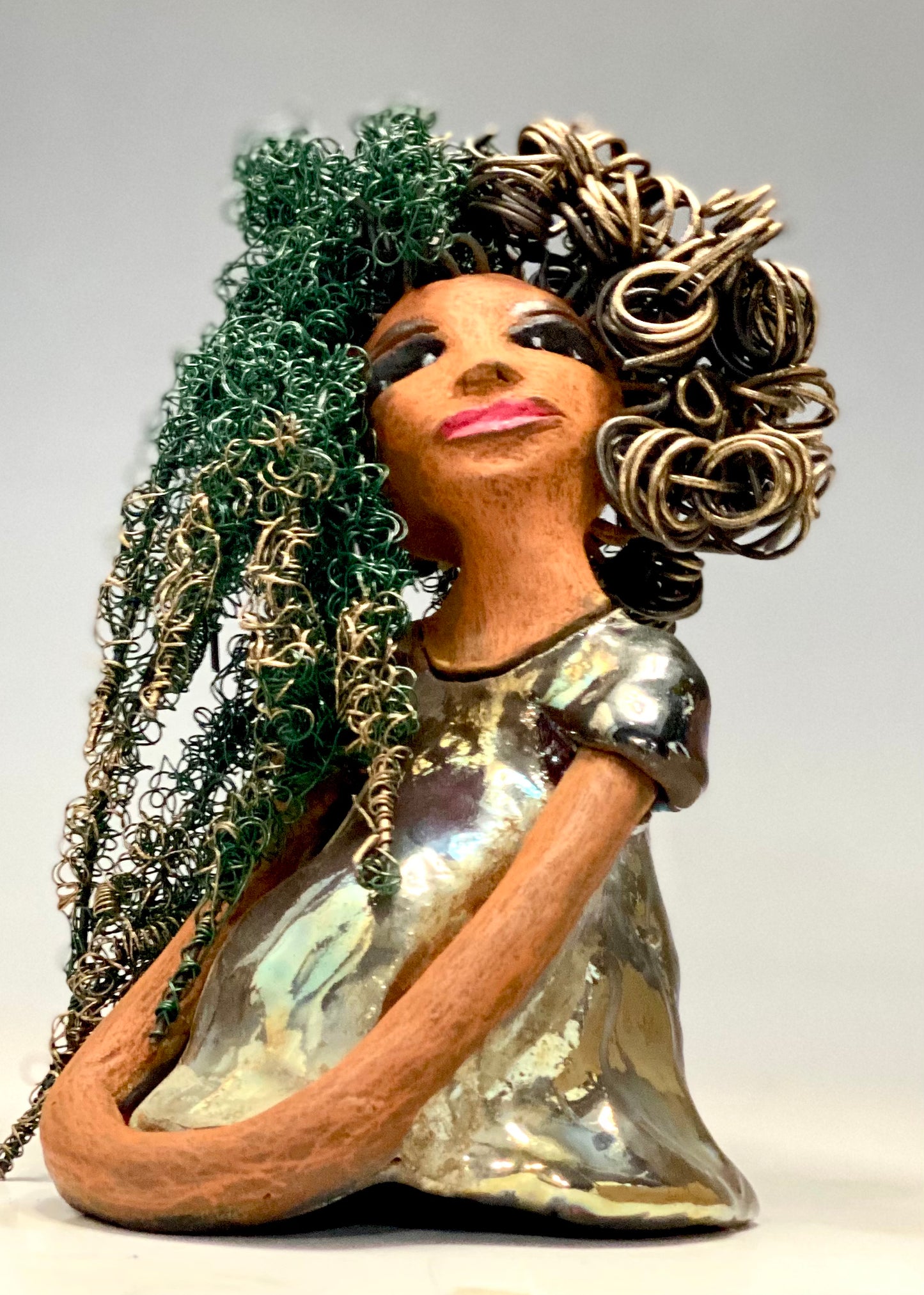 Diane stands 7" x 6" x 5.5" and weighs 1.9 lbs. She has a lovely honey brown complexion with reddish brown lips. She has long twisted wire locs hairstyle waist down!  Diane has a very colorful metallic  copper green antique glazed dress. She has over 75 feet of 16 and 24 gauge  wire for hair. It took over 6 hours just to do her hair! With  eyes wide opened, Diane has hope of finding a new home.