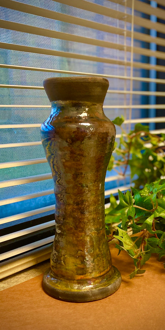 This open bottom candlestick stands 9" x 3.5" x 3.5" and weighs 1.12 lbs. It has a copper metallic glossy patina with a smokey black upper top. Looks great with dried flowers and other arrangements.