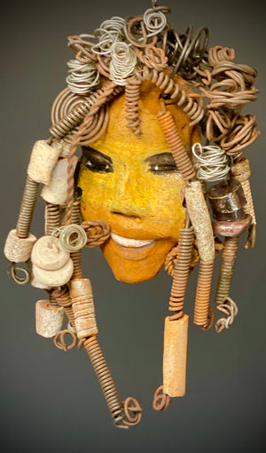 Meet Ife! I started making art soon after seeing authentic African artwork at the Smithsonian Museum of African Art. I was in total awe. Ife was inspired by my visit there.   Ife has a two tone complexion of honey mustard and dark metallic copper. She  is 8" x 6" and weighs 13 ozs. Ife has over 10 raku beads with 1 tribal beads. Ife has over 15 feet of  coiled copper and 16 gauge wire hair.