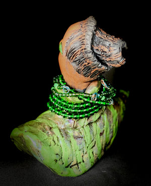 Delia looks up with joy and anticipation! Delia stands 7"x 6" x 3" and weighs 1.50 lbs. She wears an awesome metallic green textured copper robe. Delia has braided clay hair up in a bun. She has a honey brown complexion. Delia could make an excellent gift for your BFF! Delia will make for great conversation in your home. Free Shipping! Check out our Shipping  and Return policy