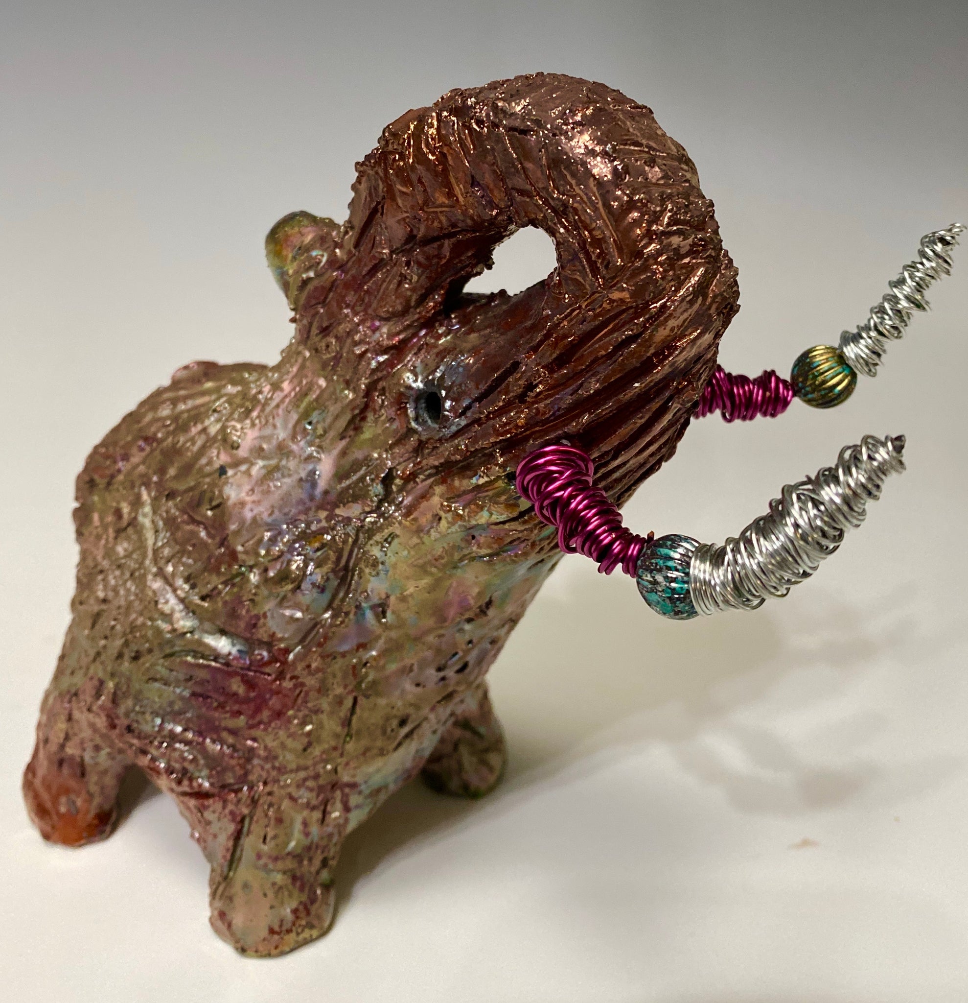 Have you HERD!!!!!!     Elephants are one of my favorite animals to create. They are so majestic"  Just one of these lovely Raku Fired Elephant will make an excellent gift for your  BFF,  or just for you .    This raku fired elephant stands 6" x 4" x 6" and weighs 1 lb. She has beaded tusks and a textured glossy gold and copper metallic body. This one is nice to add your Herdew Collection!