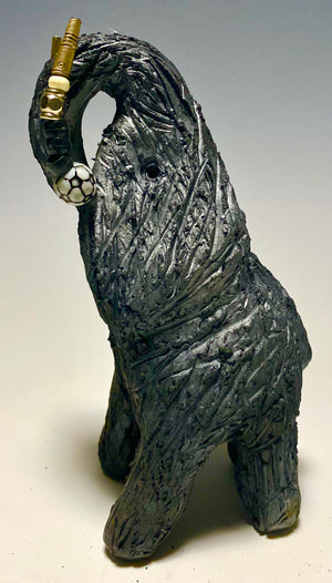 "Elephants are one of my favorite animals to create. They are so majestic" This raku fired elephant stands 7" x 2" x 2.5" and weighs 10 ounces. She has beaded tusks and a textured smokey black body. Nice! Great for a gift!