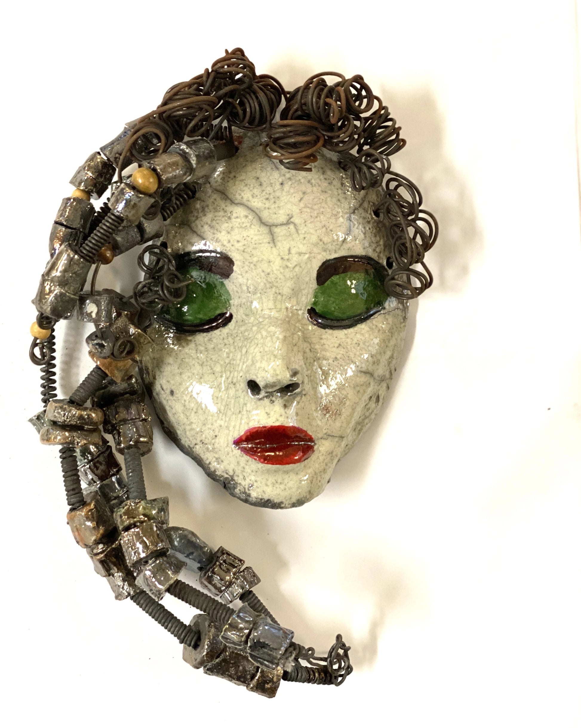 Mckenzie has a white complexion, green eye shadow, and ruby red lips! She is 7”x 5”" and weighs 1.8 lbs. Mckenzie  has over 20 handmade raku fired beads. She has over 20 feet of coiled 16 gauge wire hair.