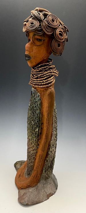 Meet Ernestine! Ernestine stands 18' x 6" x 5" and weighs 5.03 lbs. Ernestine has a lovely honey brown complexion. She has a shimmering copper dress with a huge seed bead necklace. Ernestine is a tall girl with long loving arms. It took several hours to style Ernestine's 16 gauge wire hair! With eyeglasses ,she looks as if she's dreaming or in disbelief. Ernestine is indeed a sophisticated looking lady!   Give Ernestine a new place to stay in your home!
