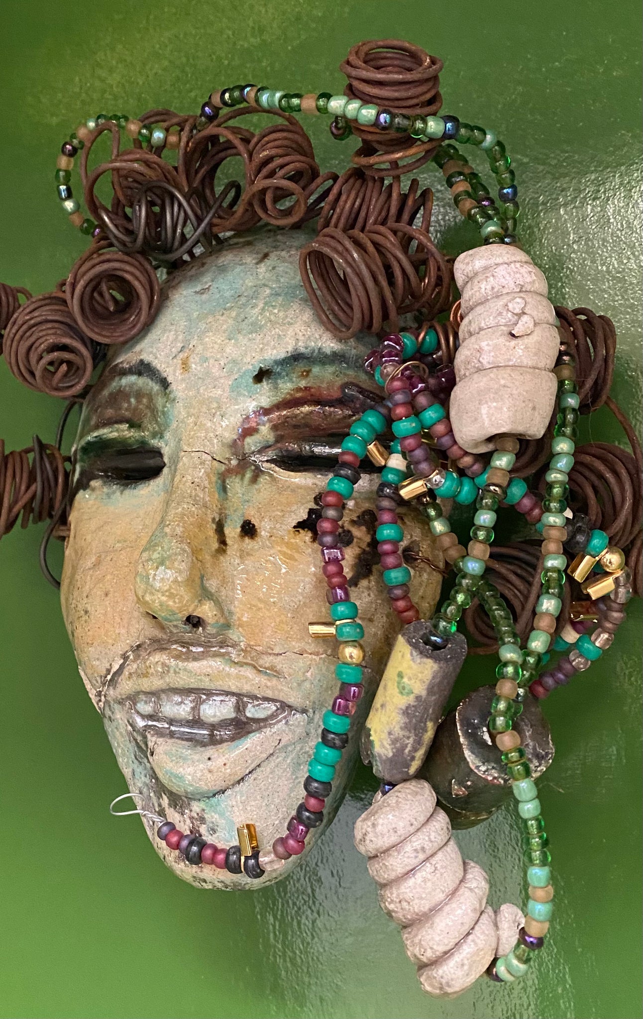  Meet Jenia! She is proud of every tooth in her mouth.... I started making art soon after seeing authentic African artwork at the Smithsonian Museum of African Art. I was in total awe. Jenia was inspired by my visit there.  Jenia  is 7”x 7” and weighs 1 lbs. She has a two tone copper and green complexion. Jenia  has six spiral coils of hair and plenty of handmade mini beaded braids.