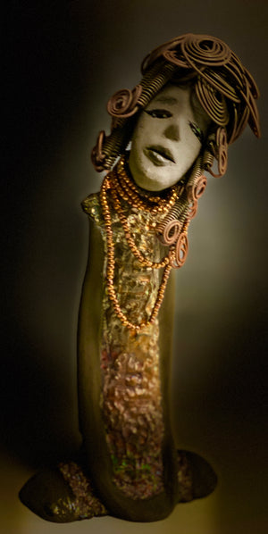 Meet Carolyn! Carolyn stands 12" x 6" x 4" and weighs 2.4 lbs. Carolyn as a lovely smokey dark complexion with honey brown eye shadow.' She wears a textured glossy copper metallic dress. Carolyn's long loving arms are at her side. It took three hours to complete her 16 gauge wire Herdew! Give Carolyn a special place in your home