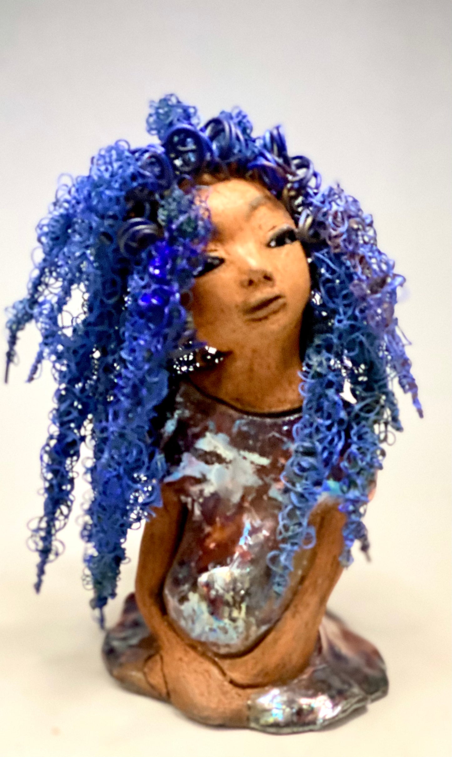 Rachel Rachel stands 8" x 6" x 5.5" and weighs 1.9 lbs. She has a lovely honey brown complexion with cocoa brown lips. She has long twisted wire locs hairstyle waist down!  Rachel has a very colorful metallic  copper blue antique glazed dress. She has over 75 feet of 16 and 24 gauge  wire for hair. It took over 6 hours just to do her hair! With  eyes wide opened, Rachel has hope of finding a new home.  