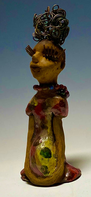  You know someone like Tiffanie. One who reaps elegance and sophistication!  Tiffanie stands 9”x 4" x 4" and weighs 1.03 lbs.  She has a two tone light beige complexion with 2 feet of 16 gauge spiral coiled wire hair.  Tiffanie metallic copper red and yellow  dress is accented by a multicolored beaded necklace. Tiffanie’s long lashes and  black eye shadow gives her a distinguished mystical look. 