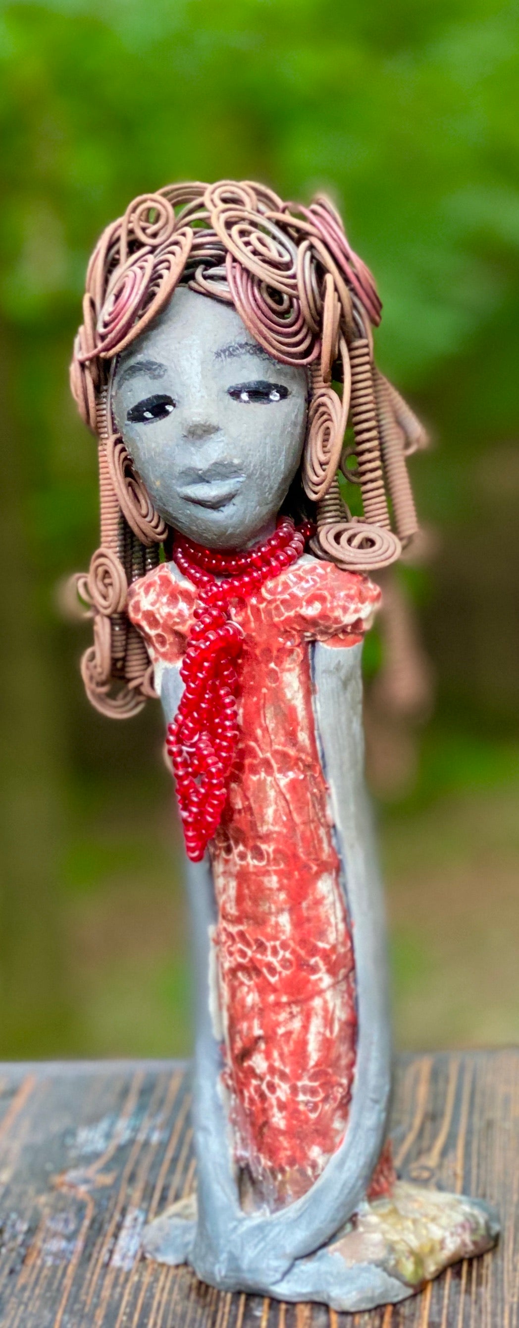 Meet Reagan! Reagan stands 12" x 4" x 4" and weighs 2.10 lbs. Reagan has a lovely dark complexion. It took over two hours to fix her Herdew! It is made of 16 gauge wire. Reagan has a shimmering  metallic copper red dress. A strand of ruby red beads hangs around her neck. Reagan and her sister Carolyn are one of a kind. ( Sold Separately) Give Reagan and Carolyn a great Home!