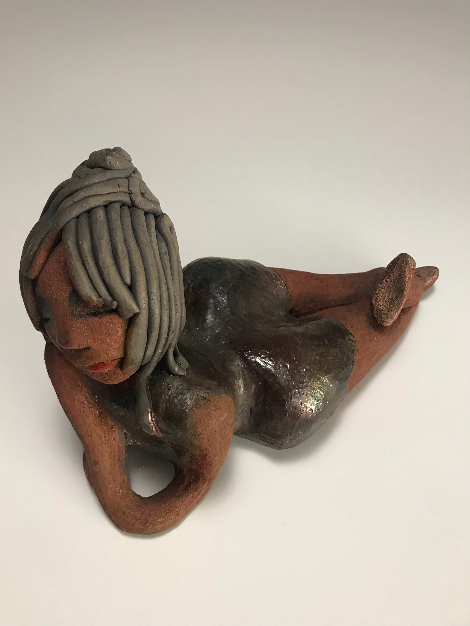      Savannah is 6 "x 4" x 9" and weighs 2.3 lbs.     She has smoky grey hair that's etched in clay.     Savannah has a dark metallic copper dress with hints of alligator green.     Savannah has a lovely copper brown complexion.     Her look says it all     What are you waiting for?  Free Shipping!