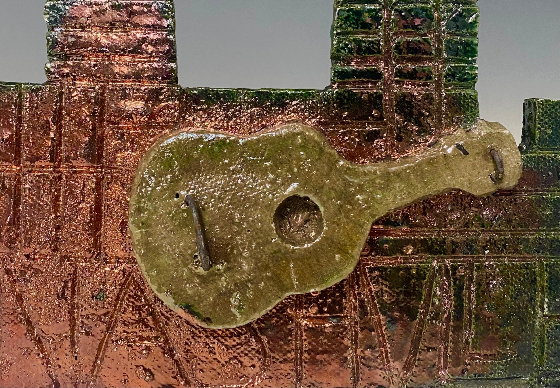 Skyline of Downtown Nashville with  country guitar!   4.5” x 5.5” (irregular cut ) 7.45 ozs Metallic copper glaze etched back hook