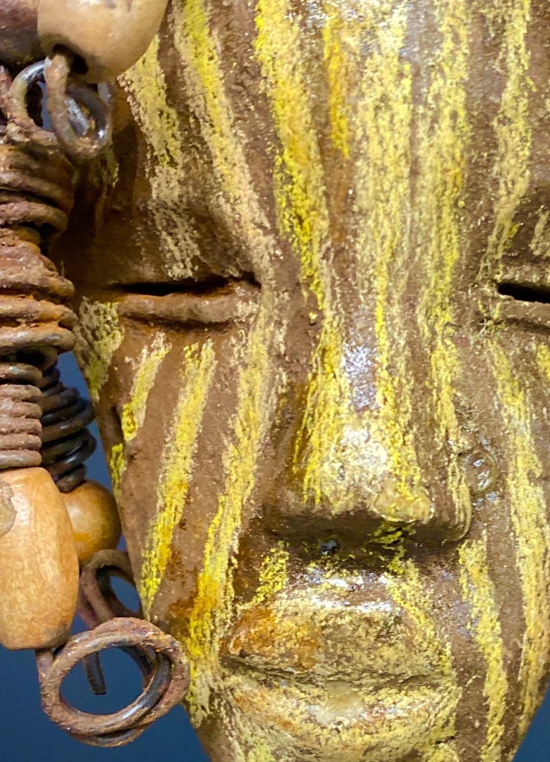 I started making art soon after seeing authentic African artwork at the Smithsonian Museum of African Art. I was in total awe.  Kaba was inspired by my visit there.   Kaba has a two tone  striped complexion of earthy gold and brown. He is 5" x 7” and weighs 1 lbs. Kaba has over 10 wooden beads. He has over 10 feet of coiled 16 gauge wire hair. If for some reason Kaba does not fit in your home, send him back for a full refund!