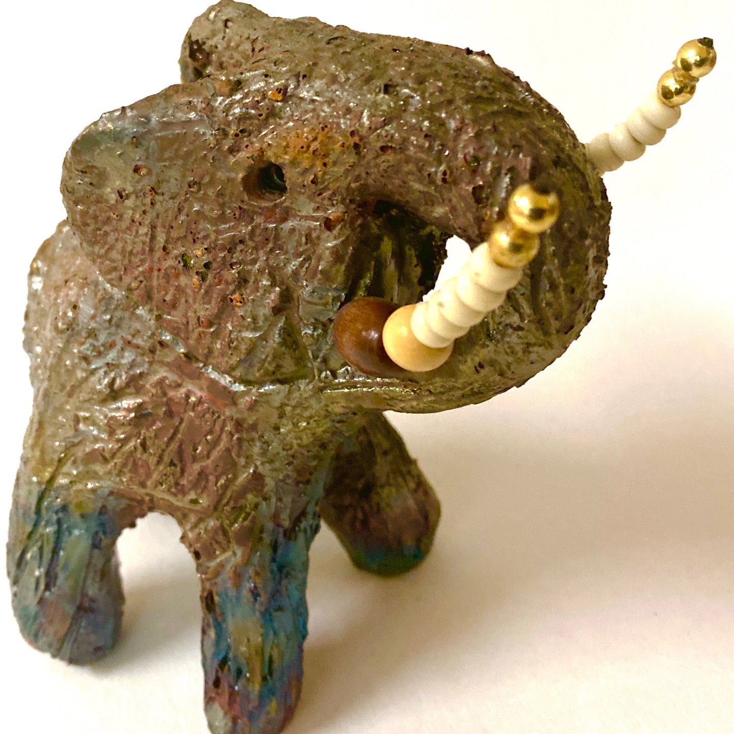 Have you HERD!!!!!!     Elephants are one of my favorite animals to create. They are so majestic"  Just one of these lovely Raku Fired Elephant will make an excellent gift for your  BFF,  or just for you .    This raku fired elephant sits 5" x 4" x 4" and weighs 1 lbs. She has beaded tusks and a textured copper charcoal body. This one will be nice to add your Herdew Collection!