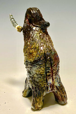 Raku Elephant Have you HERD!!!!!!  Just one of these lovely Raku Fired Elephant will make an excellent gift for your  friend, sorority or for your home’ special place centerpiece.   6" x 4" x 4" 1 lbs Beaded tusk with gold and silver wire Beautiful colorful metallic  matte raku elephant For decorative purposely only