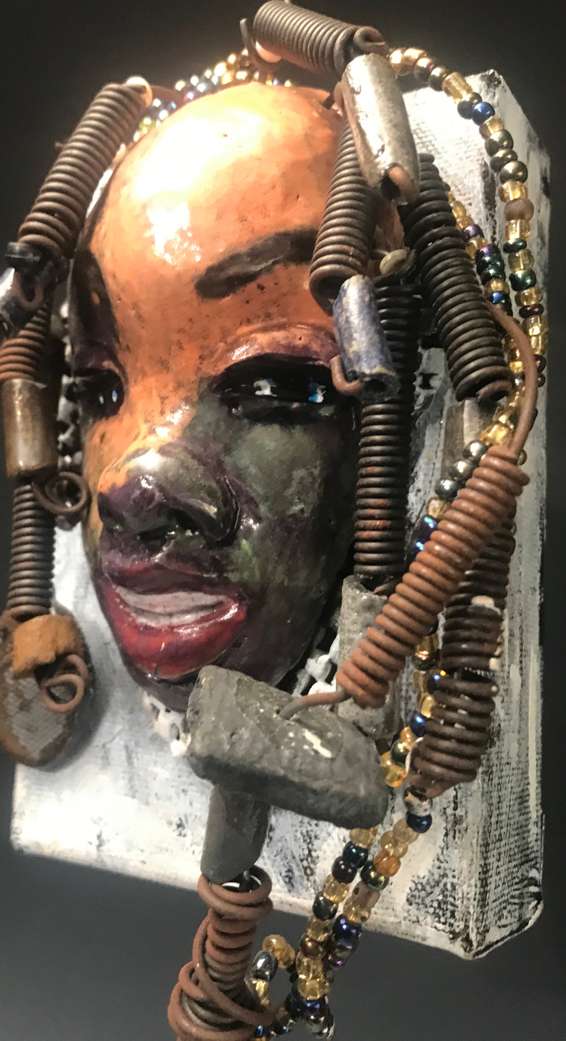      Roberta has over 20 feet of 16 gauge wire for hair and over 40 raku , acrylic, and wooden beads.     Roberta has a light pink and antique copper crackle face and lips.     Roberta  is ready to be hung!