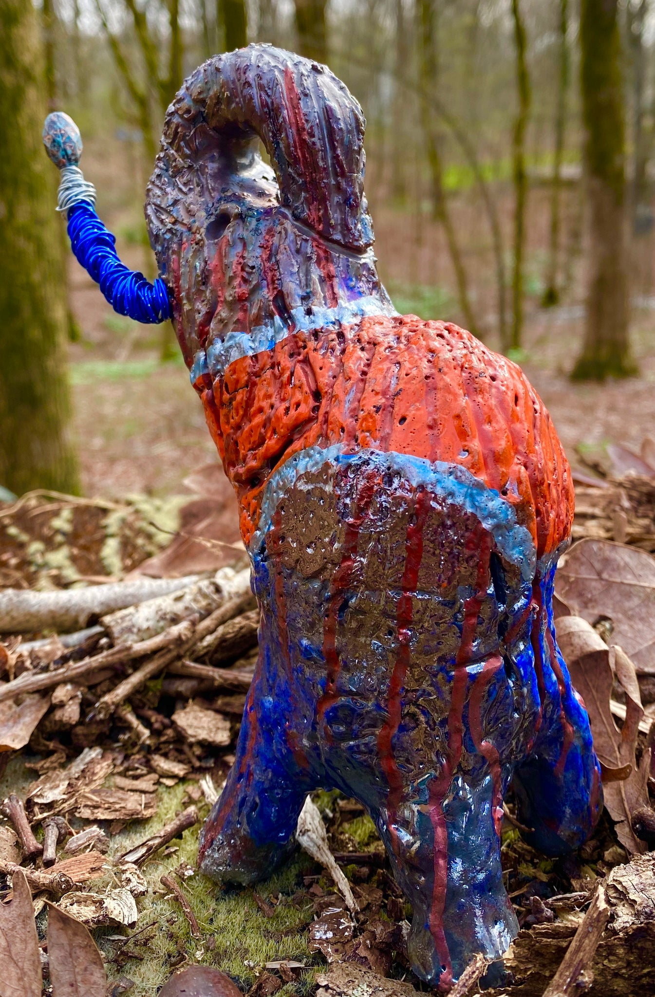 Have you HERD!!!!!!  Just one of these lovely Raku Fired Elephant will make an excellent gift for your  friend, sorority or for your home’ special place centerpiece.  7" x 4" x 4" 15 ozs. Blue wire beaded blue and silver tusk Beautiful metallic blue and orange raku colors For decorative purposely only.
