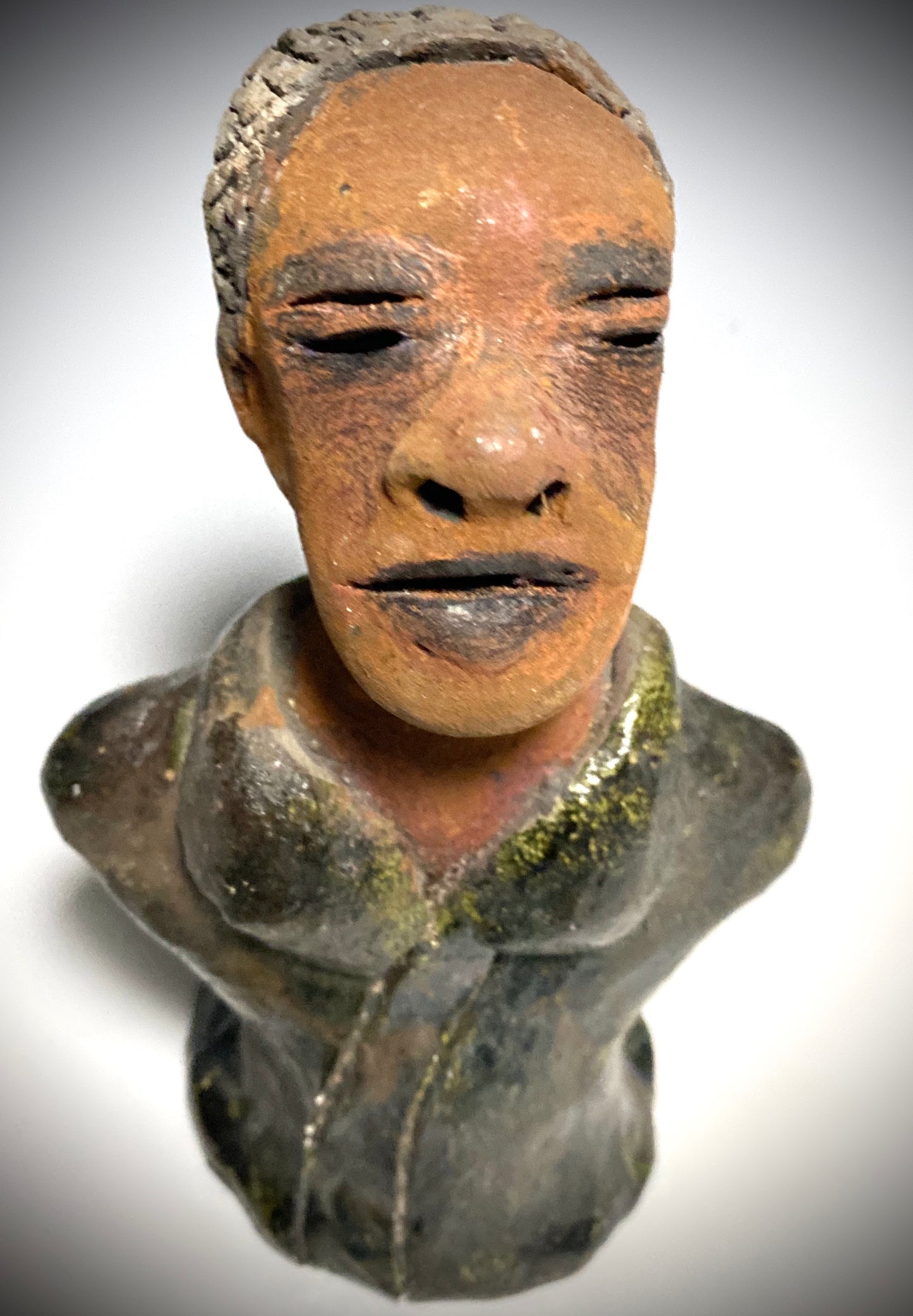 Mr. Charles has a story to tell!  Do you See the wisdom in his face? Mr. Charles  stands 5"x 3" x 2.5" and weighs 11 ozs. He wears a copper green metallic jacket. Mr. Charles's complexion is honey brown and he has salt and pepper hair.                      