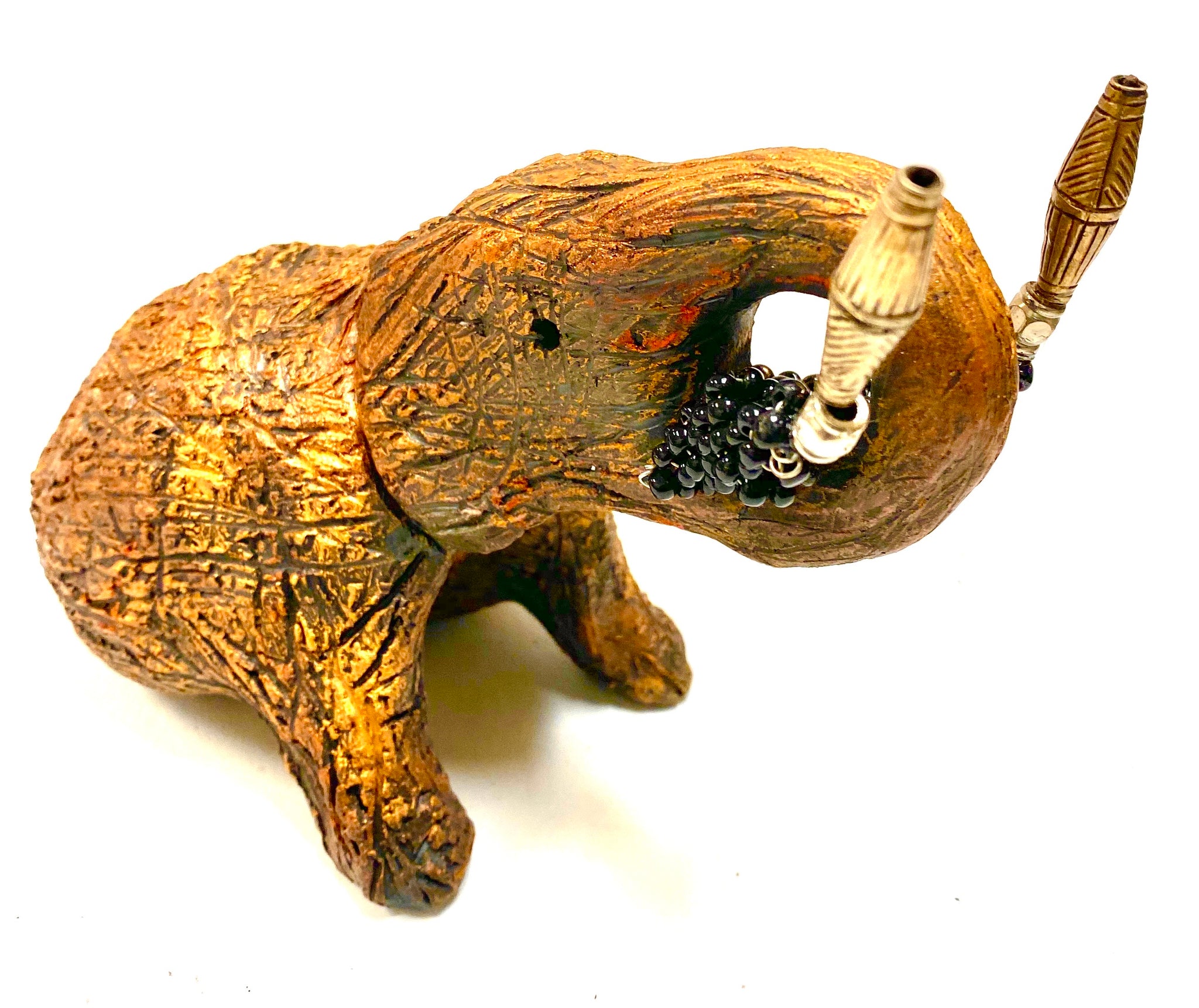 Have you HERD!!!!!!     Elephants are one of my favorite animals to create. They are so majestic"  Just one of these lovely Raku Fired Elephant will make an excellent gift for your  BFF,  or just for you .    This raku fired elephant stands 5" x 4" x 7" and weighs 1 lb. She has black beaded tusks and a textured and copper metallic body. This one is nice to add your Herdew Collection!