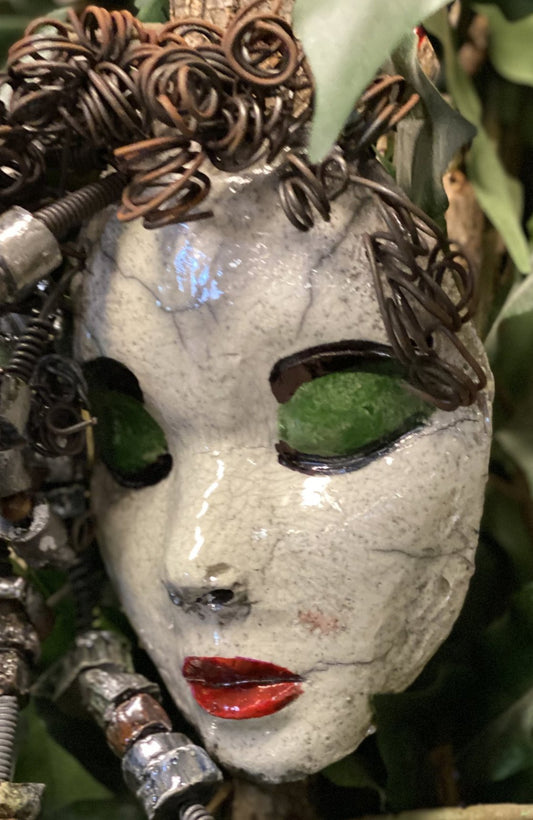 Mckenzie has a white complexion, green eye shadow, and ruby red lips! She is 7”x 5”" and weighs 1.8 lbs. Mckenzie  has over 20 handmade raku fired beads. She has over 20 feet of coiled 16 gauge wire hair.