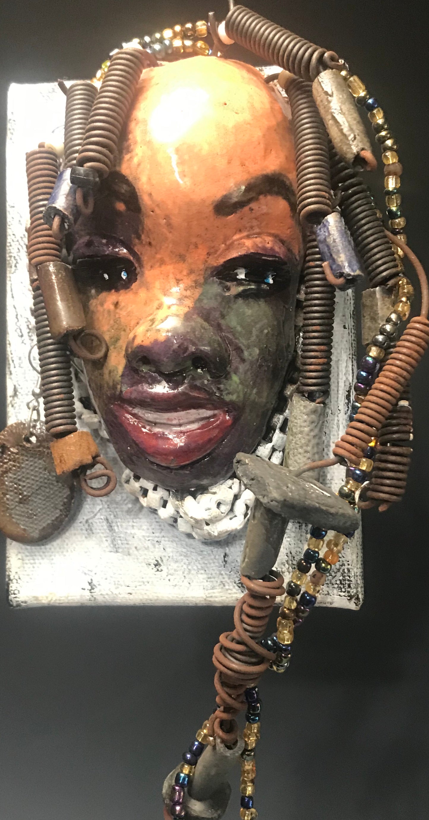      Roberta has over 20 feet of 16 gauge wire for hair and over 40 raku , acrylic, and wooden beads.     Roberta has a light pink and antique copper crackle face and lips.     Roberta  is ready to be hung!