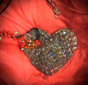  Have A Heart ! Each heart pendant is handmade with love! It is 3"x 3" and weighs approx. 3ozs. This pendant has a copper gold metallic raku glazes that renders a unique translucent  patina. The heart has a textured pattern . It holds a spiral of amber and red mini beads on a spiral copper wire. This pendant has a nice 12" black suede cord!