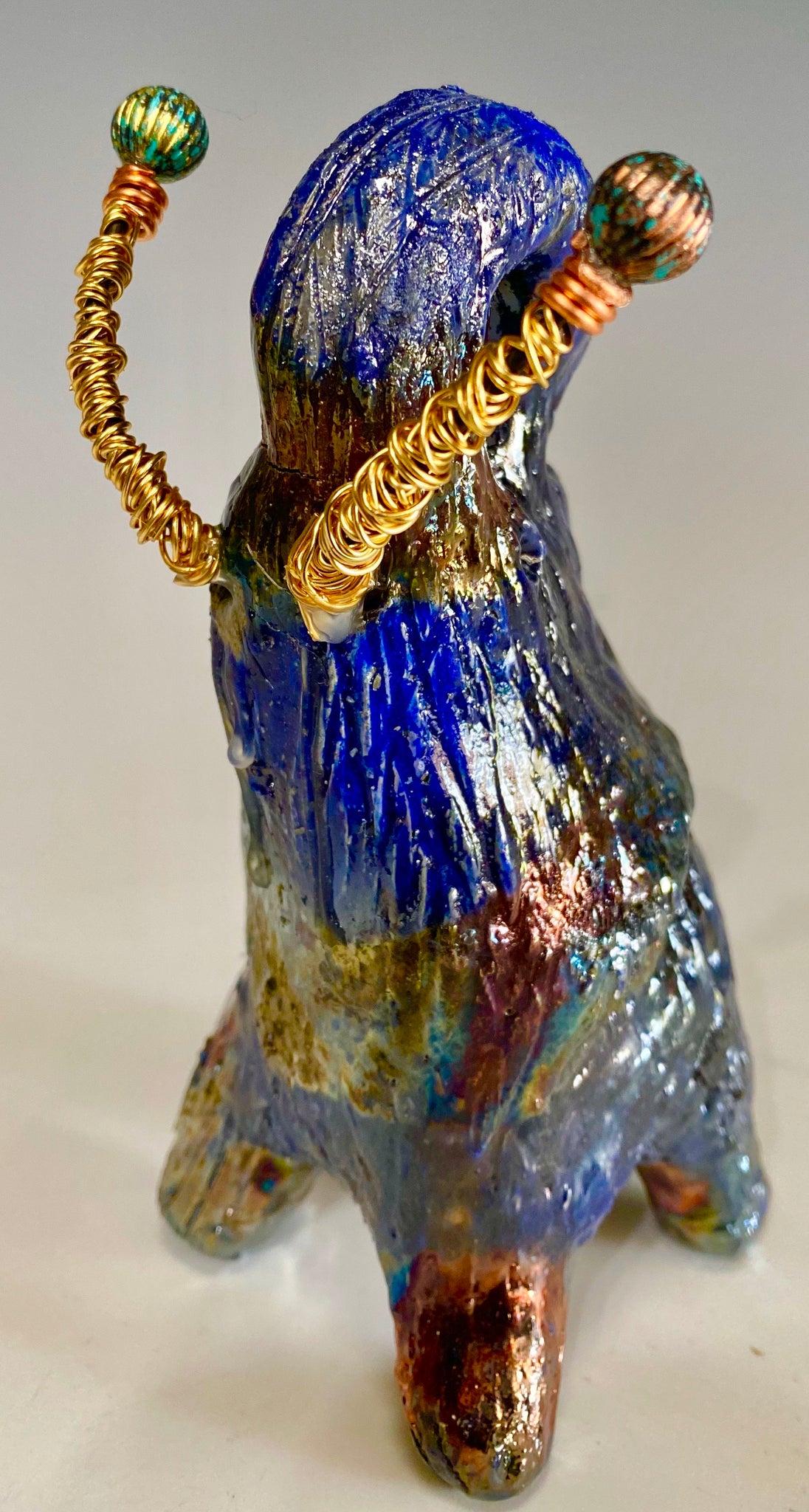 "Elephants are one of my favorite animals to create. They are so majestic" This raku fired elephant stands 6" x 3" x 5" and weighs 11 ounces. She has beaded tusks and a textured copper body. Nice!