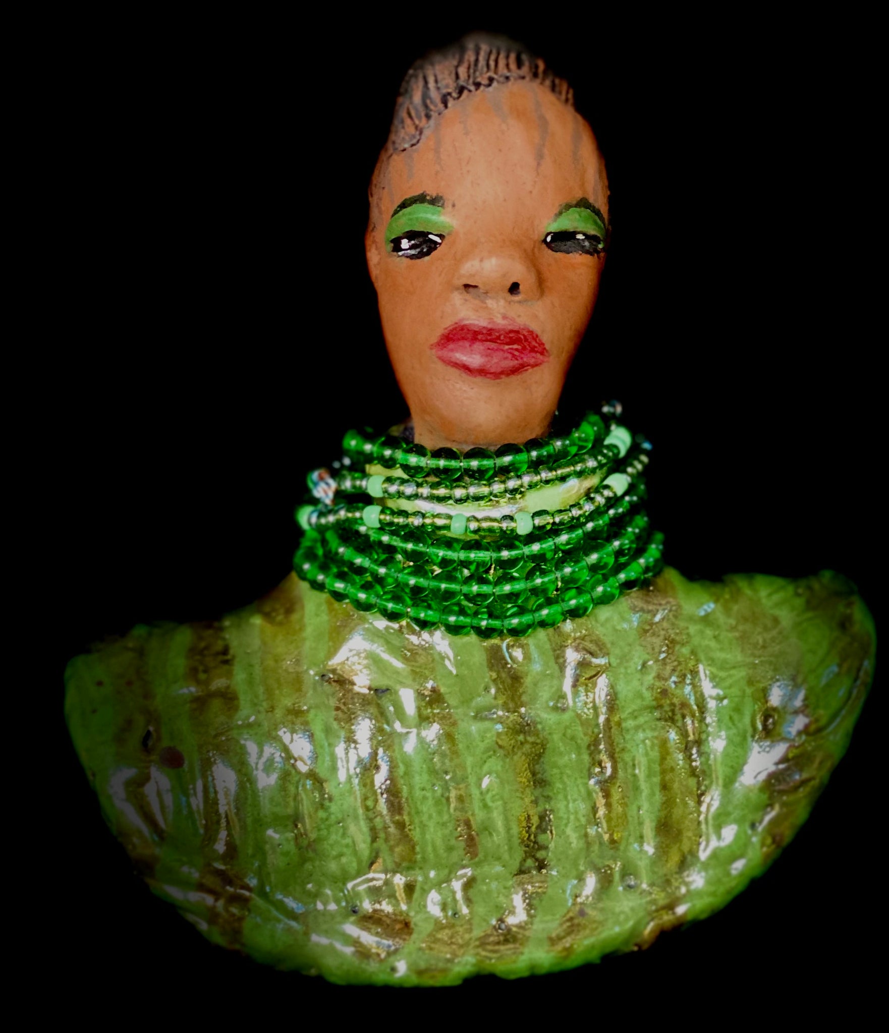 Delia looks up with joy and anticipation! Delia stands 7"x 6" x 3" and weighs 1.50 lbs. She wears an awesome metallic green textured copper robe. Delia has braided clay hair up in a bun. She has a honey brown complexion. Delia could make an excellent gift for your BFF! Delia will make for great conversation in your home. Free Shipping! Check out our Shipping  and Return policy