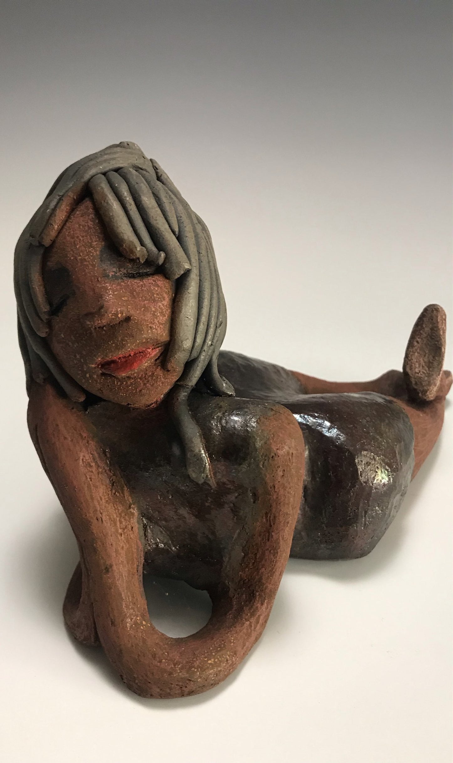      Savannah is 6 "x 4" x 9" and weighs 2.3 lbs.     She has smoky grey hair that's etched in clay.     Savannah has a dark metallic copper dress with hints of alligator green.     Savannah has a lovely copper brown complexion.     Her look says it all     What are you waiting for?  Free Shipping!