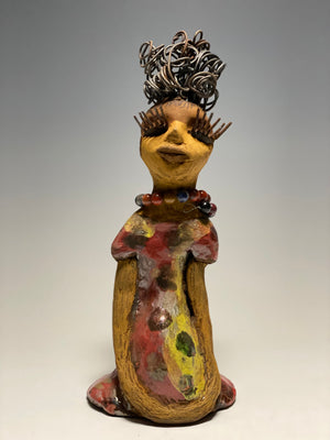  You know someone like Tiffanie. One who reaps elegance and sophistication!  Tiffanie stands 9”x 4" x 4" and weighs 1.03 lbs.  She has a two tone light beige complexion with 2 feet of 16 gauge spiral coiled wire hair.  Tiffanie metallic copper red and yellow  dress is accented by a multicolored beaded necklace. Tiffanie’s long lashes and  black eye shadow gives her a distinguished mystical look. 