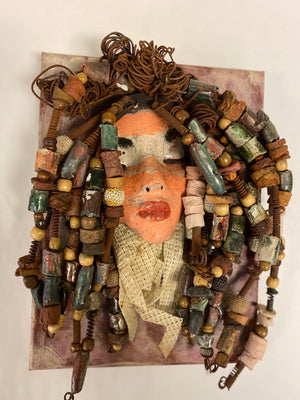  Daya is an exotic mask mounted on a painted 9"x 12" canvas.  She weighs 1.9lbs.  Daya's face is formed out of clay and raku fired.  She has over 30 feet of  hand coiled 16 gauge  wire, over 50 hand formed   raku   beads, multiple wood beads, natural river stones, with a textured  beige cloth.  Daya's face beams with light pink and white matte and ruby red lips.  She is ready to be hung!