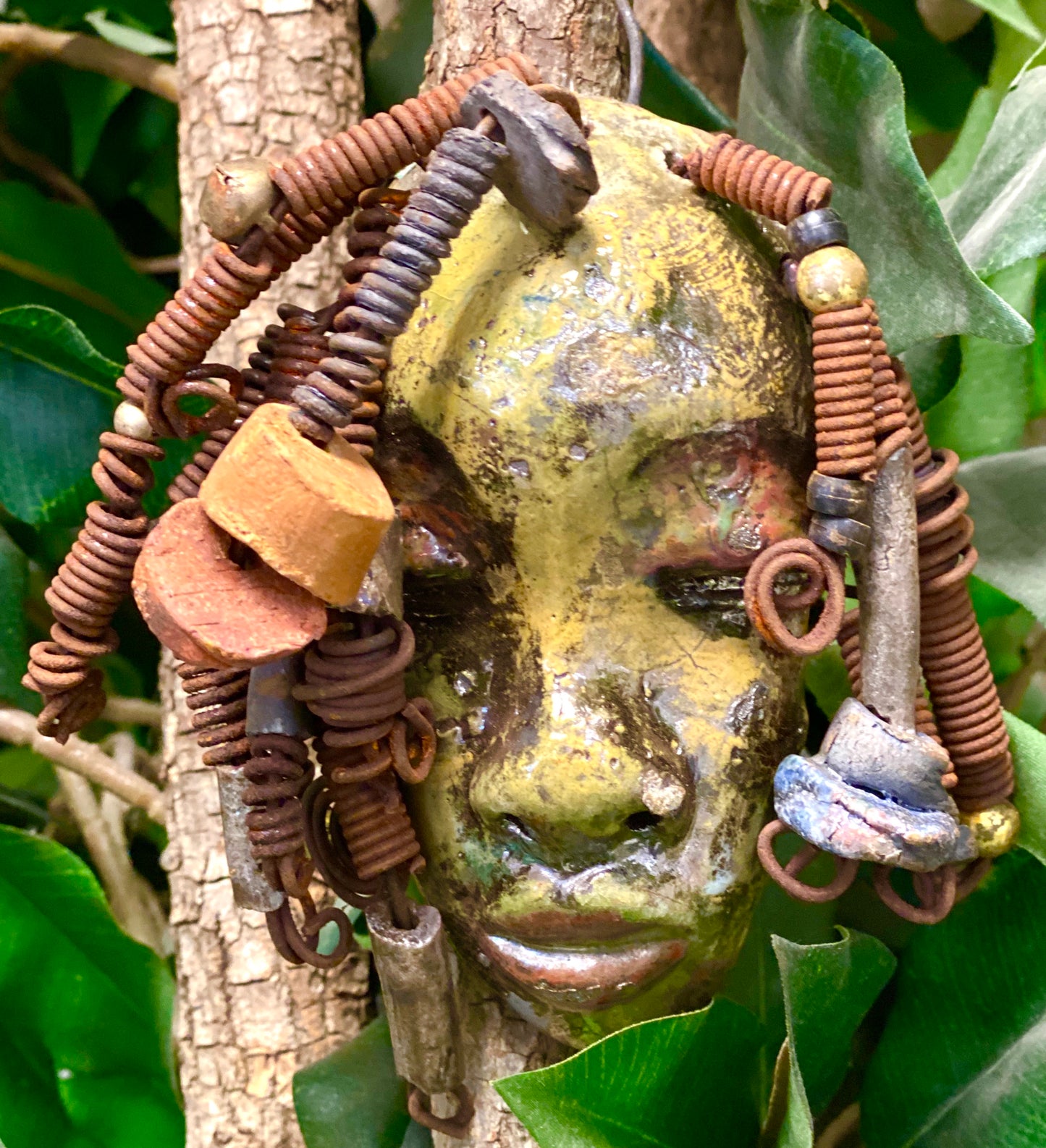 Araya has a yellow green complexion and dark red lips! She is 3”x 5”" and weighs 9 ozs. Araya  has over 5 handmade raku fired beads. She has over 20 feet of coiled 16 gauge wire hair.