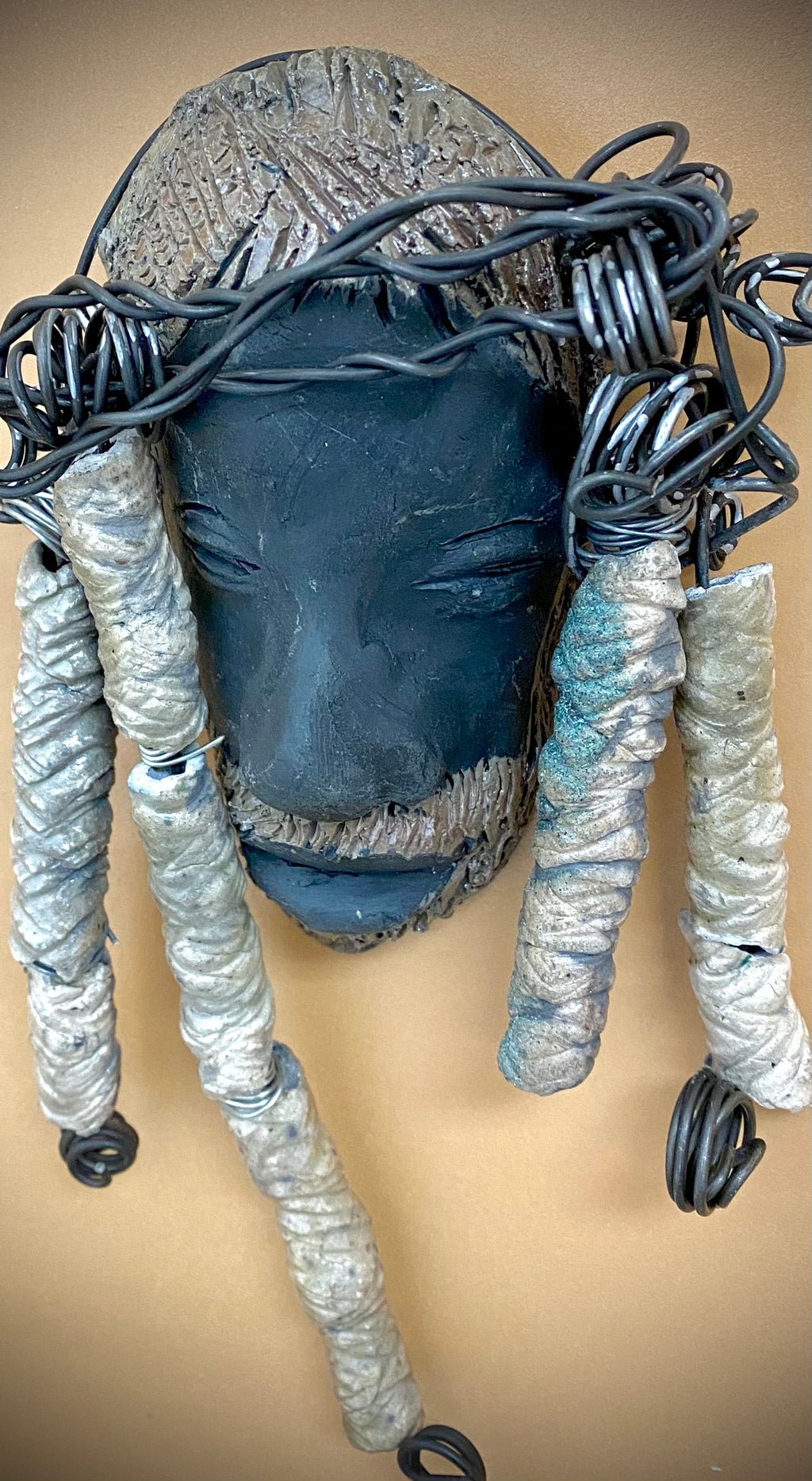 Meet Afumba! I started making art soon after seeing authentic African artwork at the Smithsonian Museum of African Art. I was in total awe. Afumba was inspired by my visit there.   Afumba is a wise and distinguished  bearded gentleman who has a smoky dark complexion. He is approximately 8" x 4" and weighs 10 ozs. Afumba has an aged hairstyle of 10 handmade textured off white clay dreadlocks along with twist of coiled 16 gauge wire.