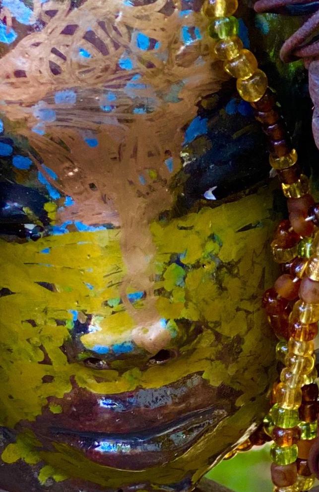 I started making mask soon after seeing authentic African artwork at the Smithsonian Museum of African Art. I was in total awe. Marali means she who listen  was inspired by my visit there.  Marali has a two tone  metallic blue copper gold complexion. She is 7" x 5" and weighs 14 ozs. Marali has  over 20 handmade raku fired beads. She has over 50 mini amber bead twisted as hair. Marali has over 6 feet of  copper coiled 16 gauge wire hair.