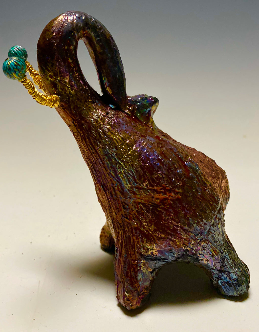 Have you HERD!!!!!!     Elephants are one of my favorite animals to create. They are so majestic"  Just one of these lovely Raku Fired Elephant will make an excellent gift for your  BFF,  or just for you .    This raku fired elephant stands 6" x 2" x 2.5" and weighs  12  ounces. She has beaded tusks and a textured copper metallic  body. Perfect for a gift or to add to your collection.