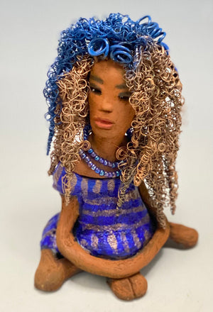 Sherrie stands 6" x 4" x 4.5" and weighs 12.6 ozs. She has a lovely honey brown complexion with reddish brown lips. Sherrie's hairstyle is made up of over 75 feet of twisted 24 gauge wire.  Sherrie has a striped metallic  copper and blue glazed dress. She wears a  aqua blue beaded necklaces. With  eyes wide opened, Sherrie has hope of finding a new home. She will make an excellent starter piece from the HerDew collection!