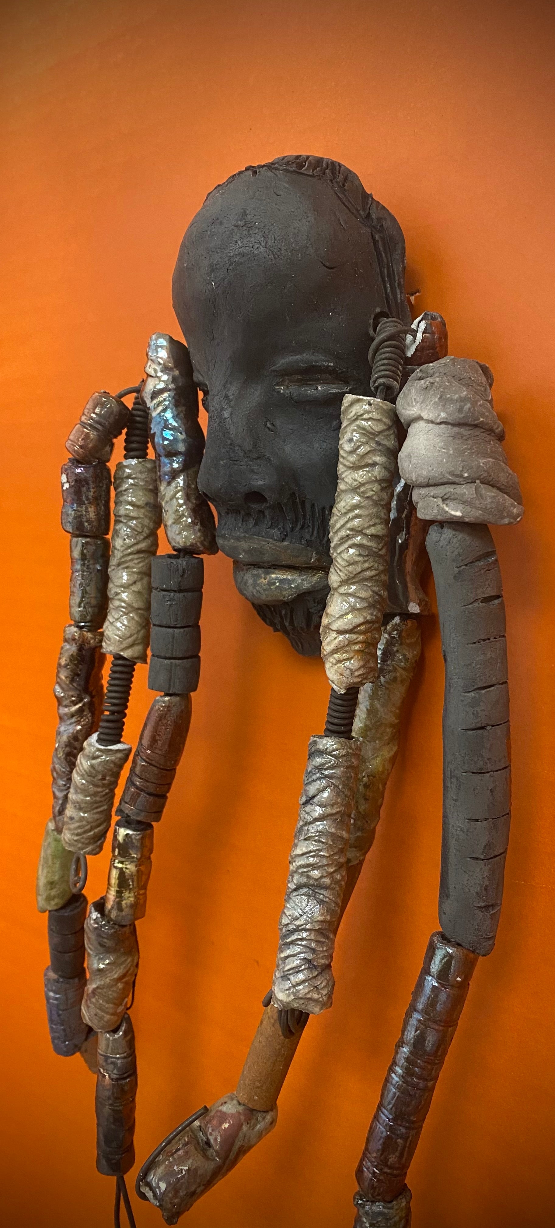 Meet Cain! You Like Wise men; You gotta Love Cain! I started making art soon after seeing authentic African artwork at the Smithsonian Museum of African Art. I was in total awe. Cole was inspired by my visit there.   Cain is a wise and distinguished  bearded gentleman who has a smoky dark complexion. He is approximately 5" x 11" and weighs 13 ozs. Cain has an aged hairstyle of more than 20 handmade textured clay dreadlocks along with twist of coiled 16 gauge wire.