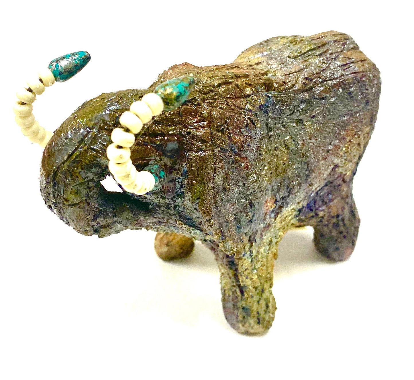 Have you HERD!!!!!!     Elephants are one of my favorite animals to create. They are so majestic"  Just one of these lovely Raku Fired Elephant will make an excellent gift for your  BFF,  or just for you .    This raku fired elephant sits 4.5" x 3" x 4" and weighs 1 lbs. She has beaded tusks and a textured copper charcoal body. This one will be nice to add your Herdew Collection!
