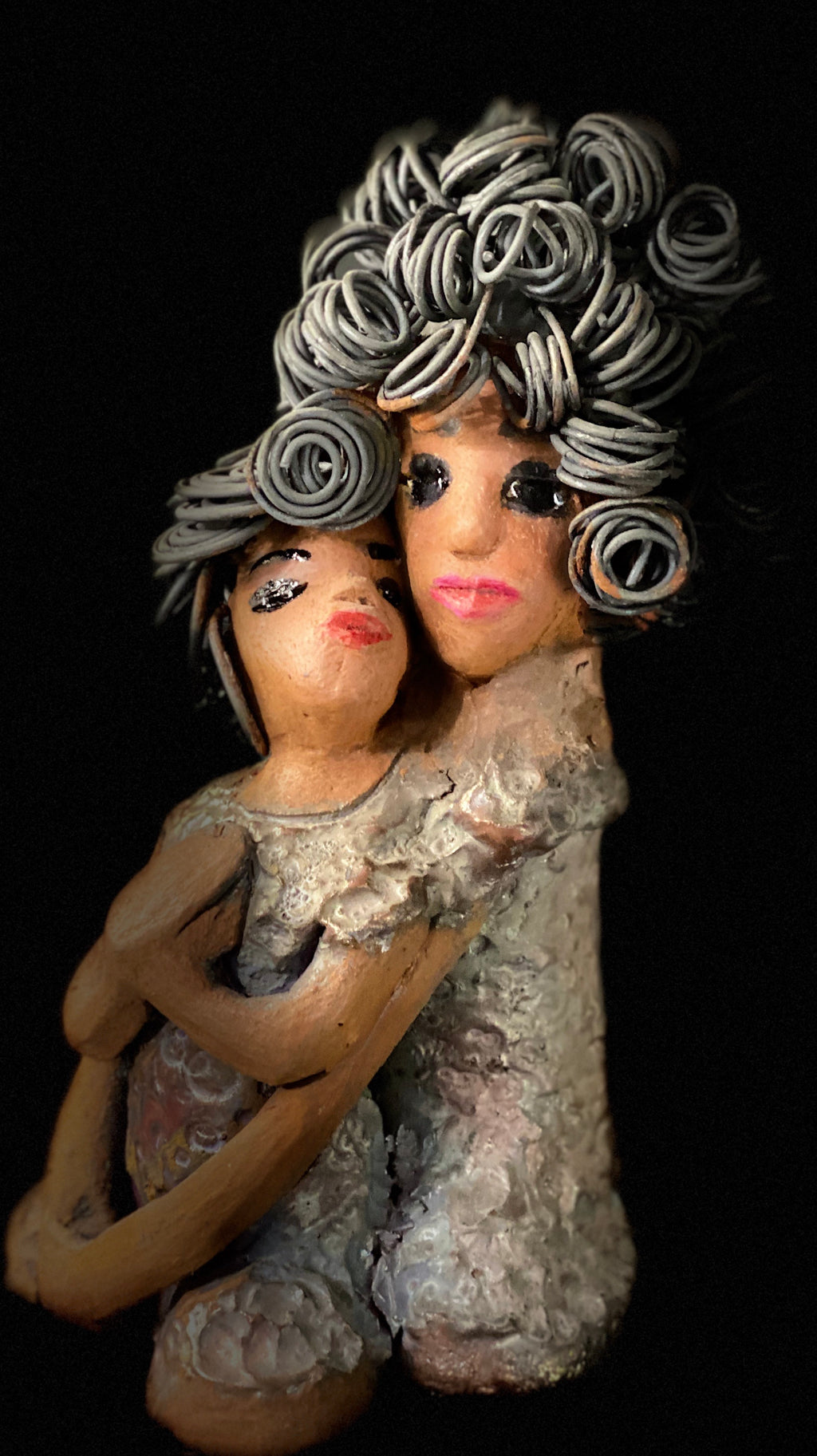 I love You! I Love You stands 8.5 " x 4.5" x 4".5" and weighs 2.10 lbs. They have lovely honey brown complexions. Combined, I Love You  has over 25 feet of curly wire hair. Their dresses are glossy metallic copper. With their long loving arms, one embraces the other I Love You! will  help illustrate the love that is in your home!