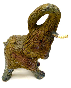 Raku Elephant Have you HERD!!!!!!  Just one of these lovely Raku Fired Elephant will make an excellent gift for your  friend, sorority or for your home’ special place centerpiece.  8" x 3" x 4" 1 lbs Beautiful metallic raku elephant white and silver beaded tusks For decorative purposely only.