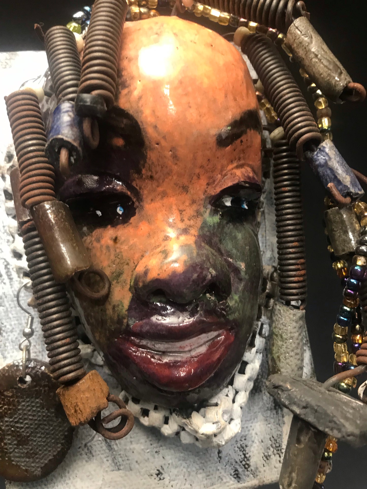      Roberta has over 20 feet of 16 gauge wire for hair and over 40 raku , acrylic, and wooden beads.     Roberta has a light pink and antique copper crackle face and lips.     Roberta  is ready to be hung!