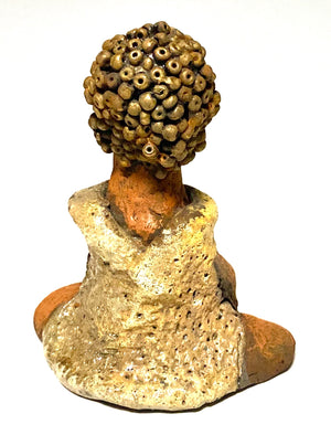 Meet Little Marissa! Marissa stands 4.5" x 4" x 2.5" and weighs 6.7 ozs.  Marissa has a lovely glossy gold dress.  She gold beaded hair. Marissa  appears to sit in a yoga pose. Her long arms rest at her side. Marissa is a great starter piece from the Herdew Collection!